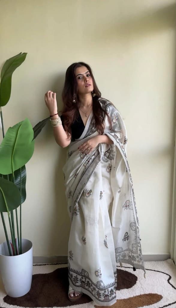 Woman wearing the Meadow Folk cream saree with folk embroidery